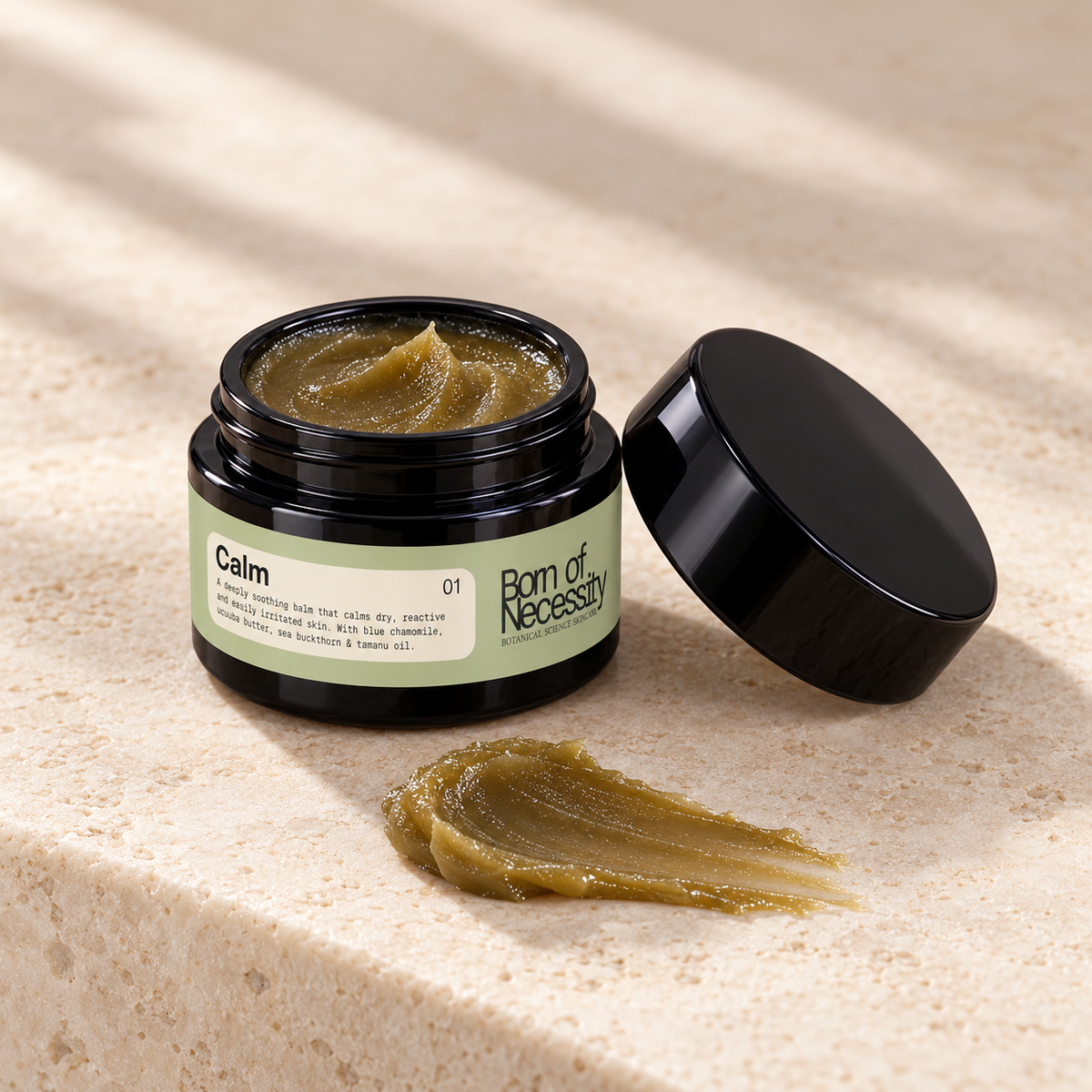 Open Calm jar showing olive brown-green balm and a texture swipe