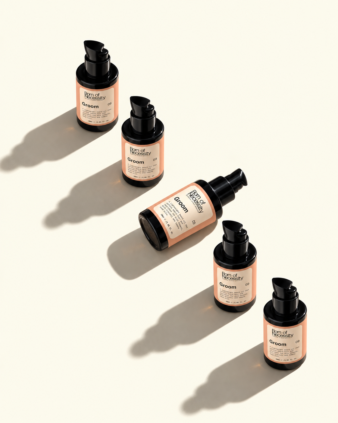 Five Groom beard oil bottles arranged in natural sunlight.