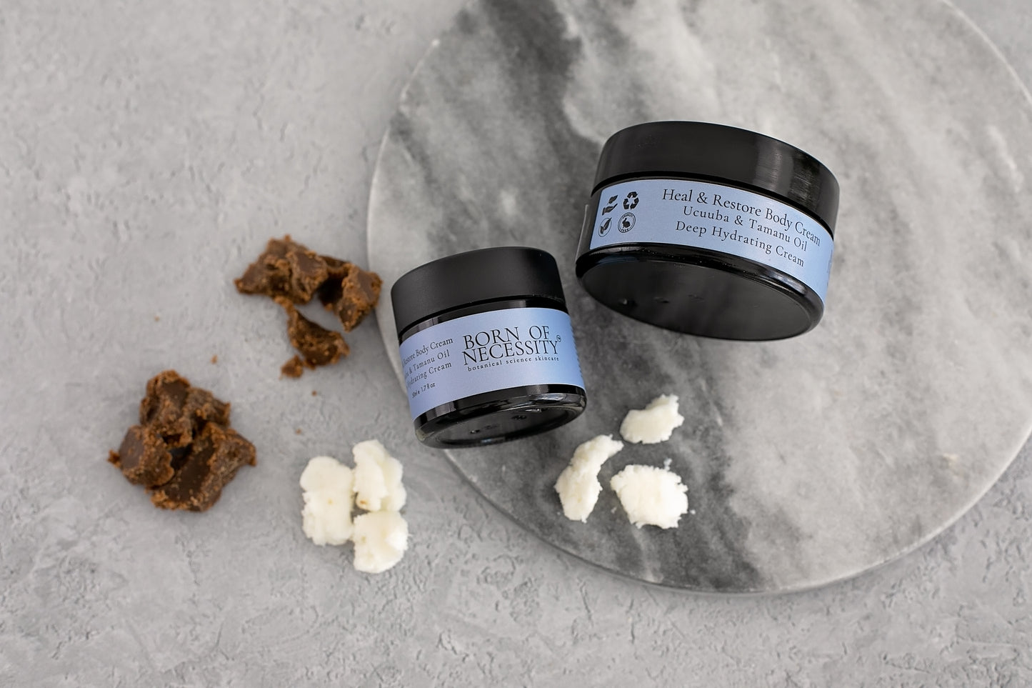 heal and restore healing cream for eczema & psoriasis prone skin , with blue chamomile healing cream on a surface surrounded by butters