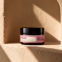 Nourish balm jar on a warm stone alcove