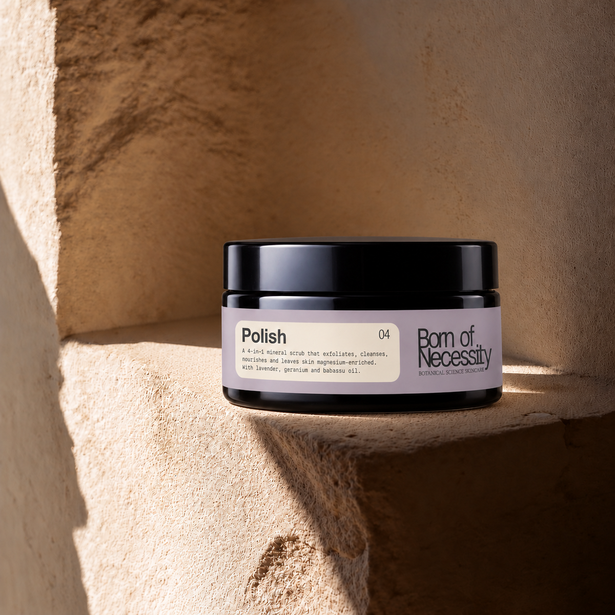 Polish 200g mineral body scrub jar on the signature sunlit stone ledge