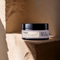 Polish 200g mineral body scrub jar on the signature sunlit stone ledge