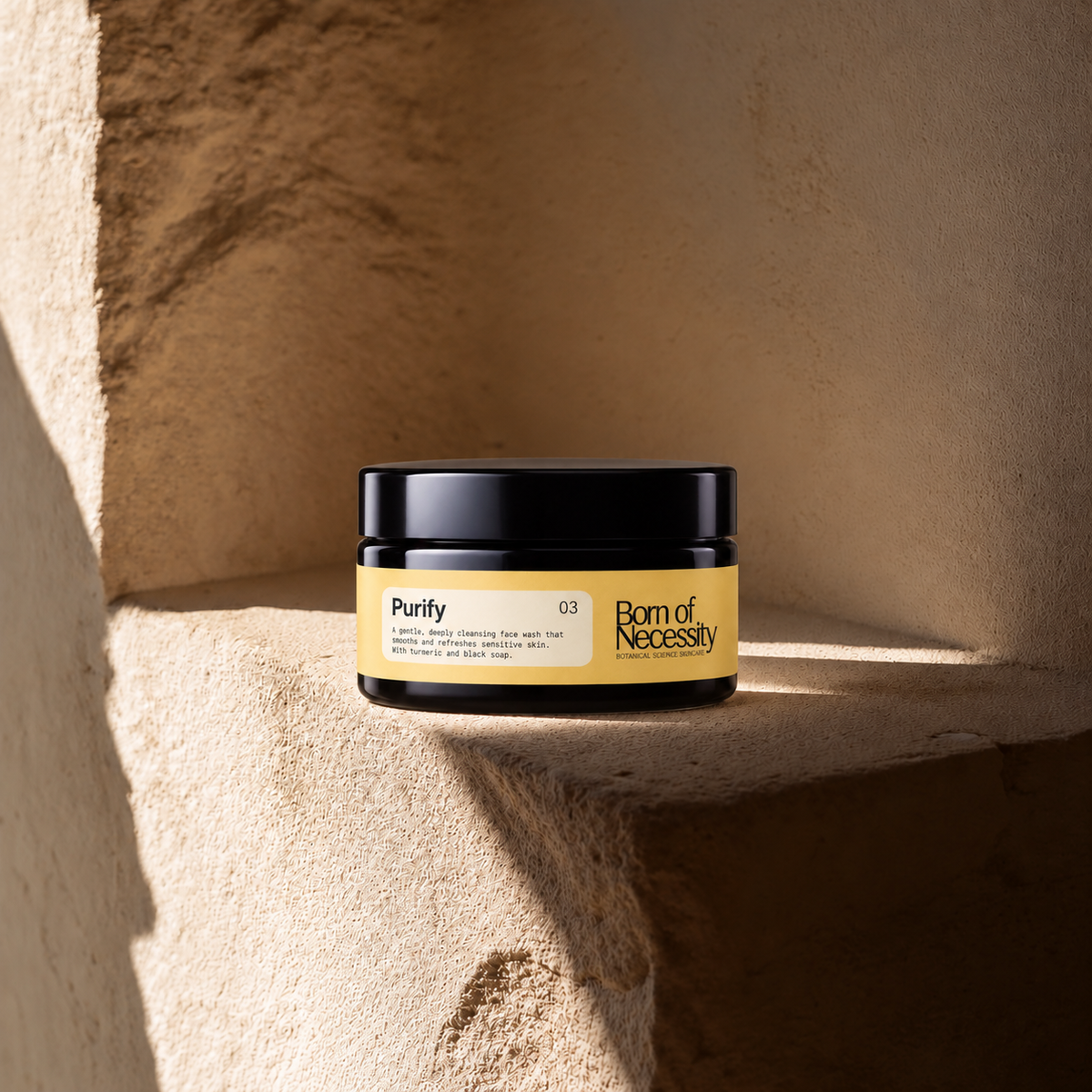 Purify 50g face wash jar on the signature sunlit stone ledge