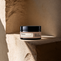 Restore hemp and oat balm jar on the signature sunlit stone ledge