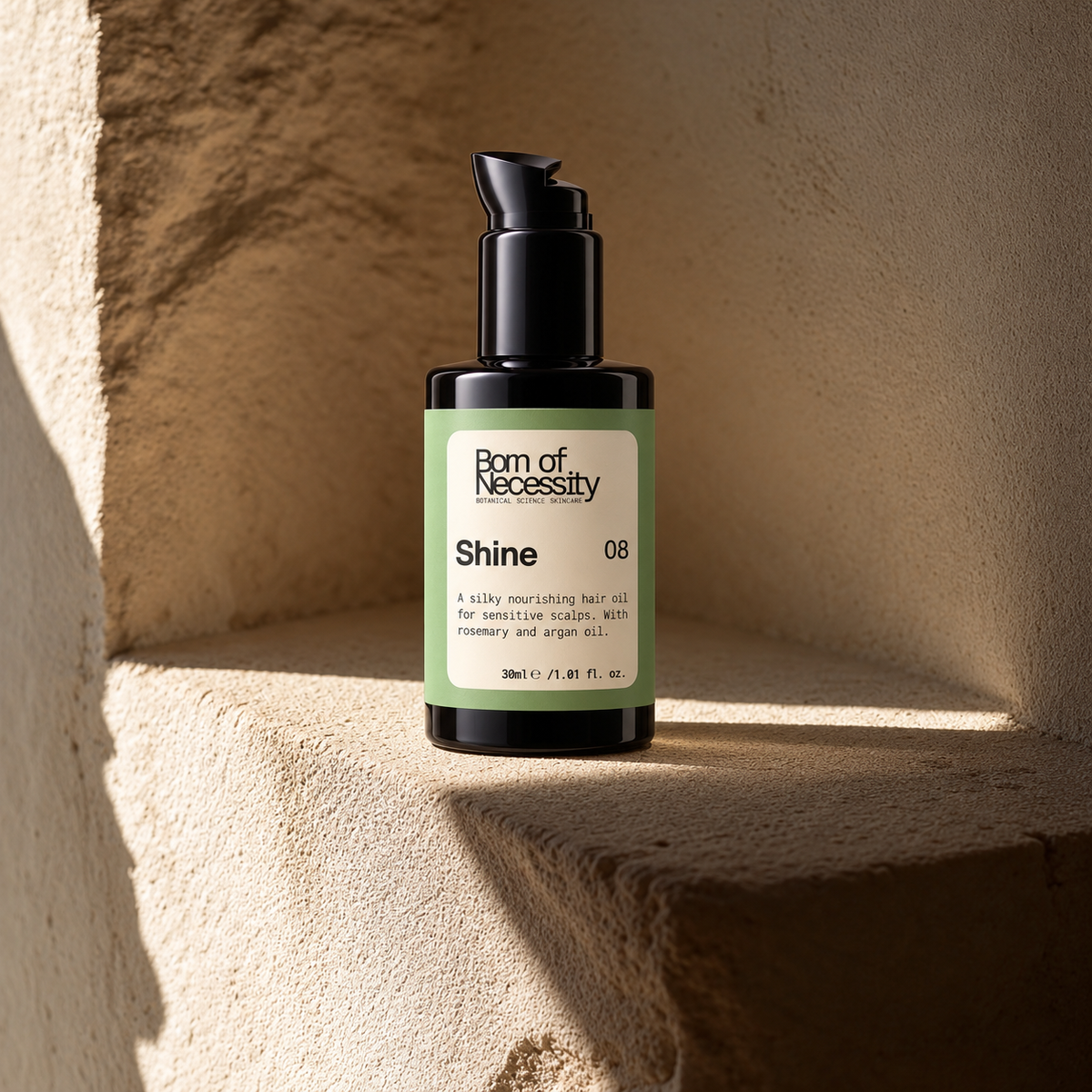 Shine rosemary and argan hair oil in a sunlit stone alcove.